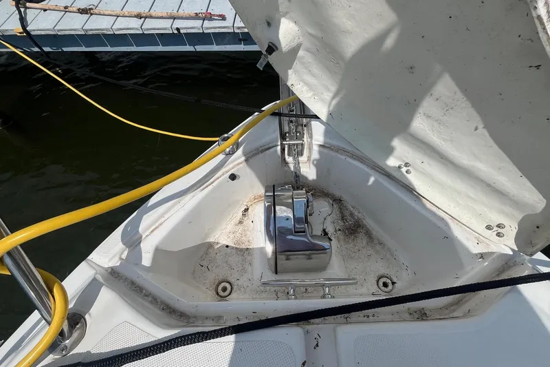 Slide: The Image of 2020 Rinker 290 EX boat anchor compartment with open hatch and visible cables. - 4