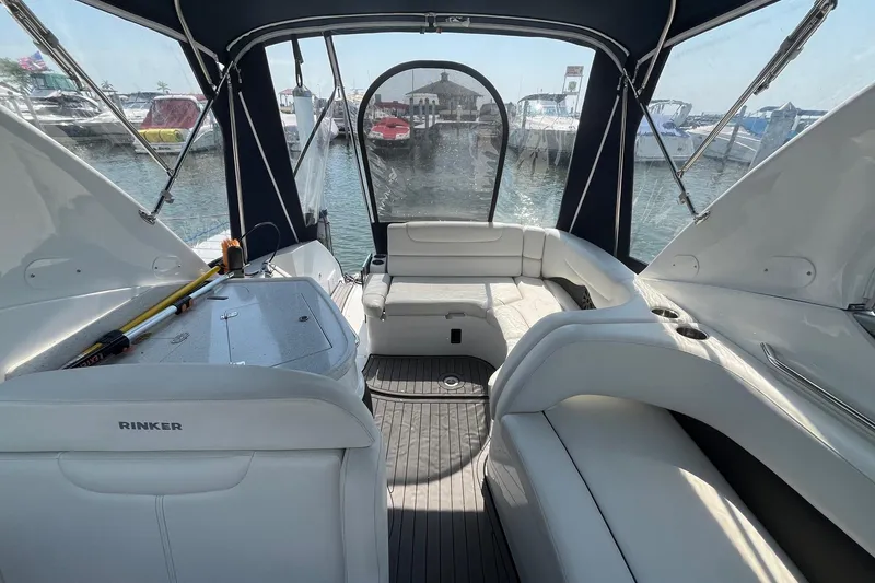 Slide: The Image of 2020 Rinker 290 EX boat interior with seating, docked at marina. - 6