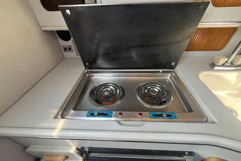 Slide: The Image of 1991 Sea Ray 300 Weekender boat kitchen with dual electric stove burners. - 18