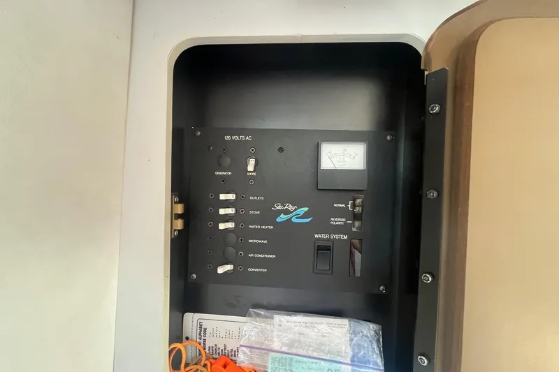 Slide: The Image of Electrical panel of a 1991 Sea Ray 300 Weekender boat, showing various switches and controls. - 20