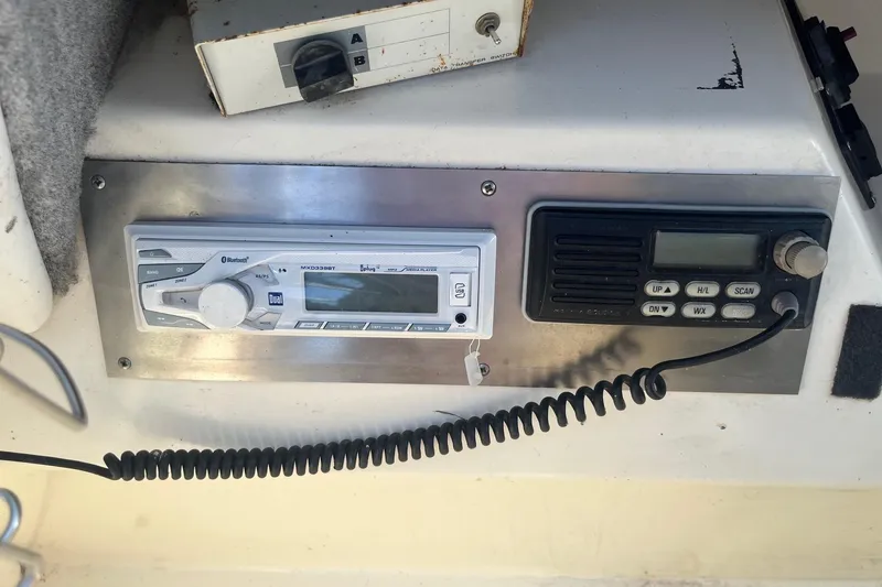 Slide: The Image of 1991 Sea Ray 300 Weekender dashboard with radio and communication equipment. - 23