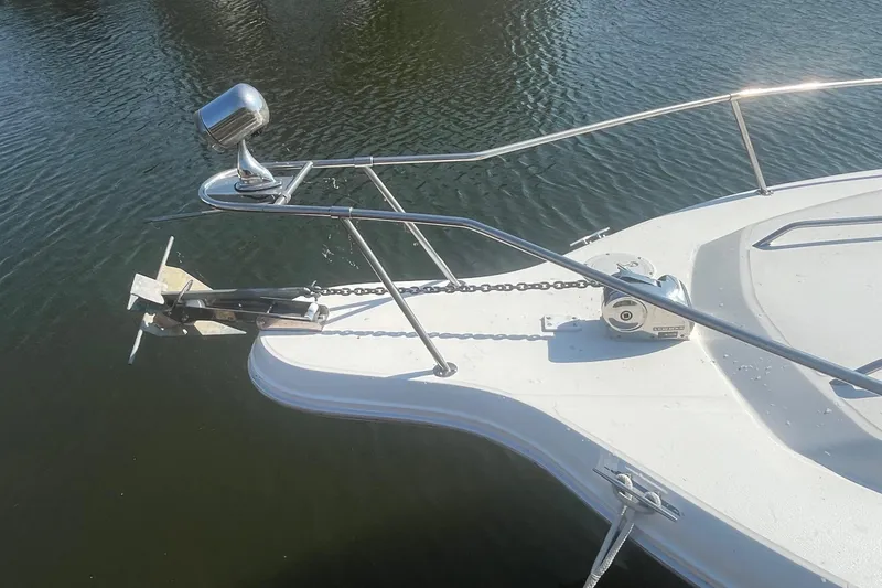 Slide: The Image of Bow of 1991 Sea Ray 300 Weekender with anchor and railing on calm water. - 5