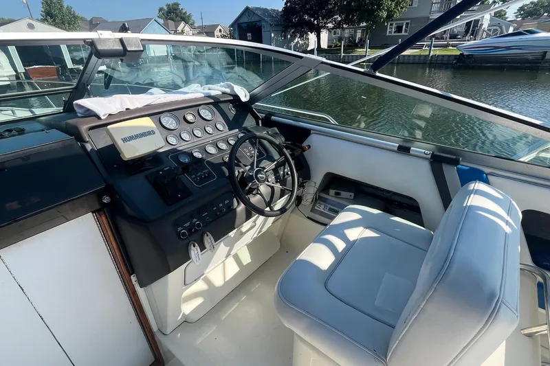 Slide: The Image of 1991 Sea Ray 300 Weekender boat cockpit with steering wheel and control panel. - 7