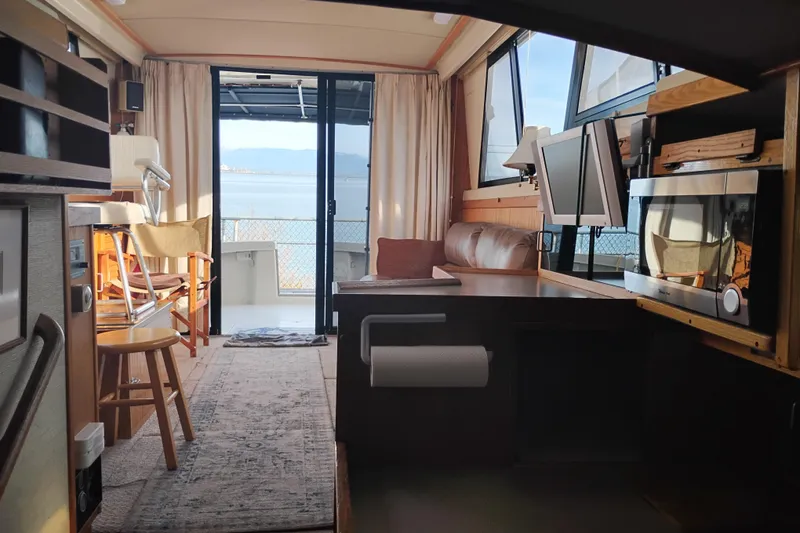 Slide: The Image of Interior of a 1985 Mainship 34 Mk III yacht with cozy seating and ocean view. - 10