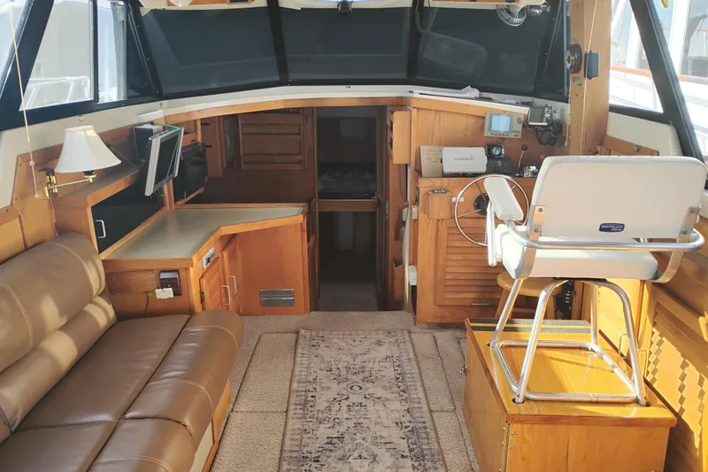 Slide: The Image of Interior of 1985 Mainship 34 Mk III boat with seating and navigation area. - 11
