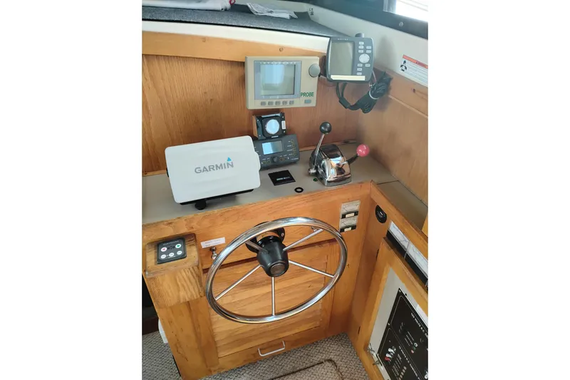 Slide: The Image of 1985 Mainship 34 Mk III helm with Garmin navigation and control instruments. - 13