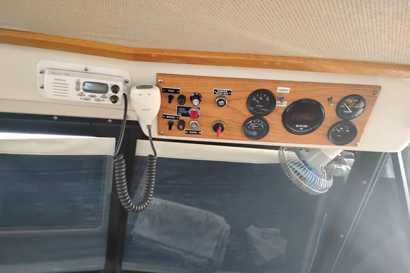 Slide: The Image of Control panel of a 1985 Mainship 34 Mk III boat with gauges and radio. - 15