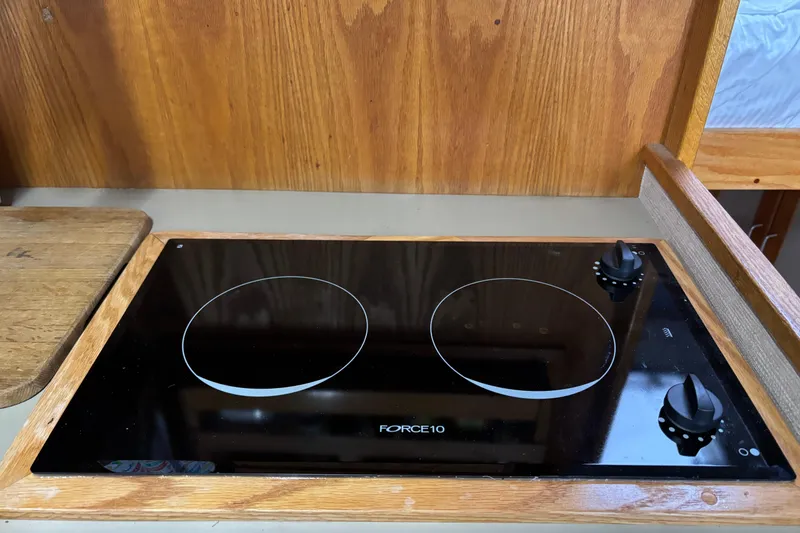 Slide: The Image of Force 10 stovetop on 1985 Mainship 34 III boat, wooden countertop background. - 20