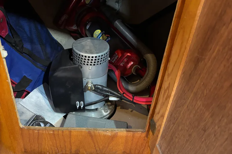 Slide: The Image of 1985 Mainship 34 III engine compartment with mechanical components and wiring. - 23