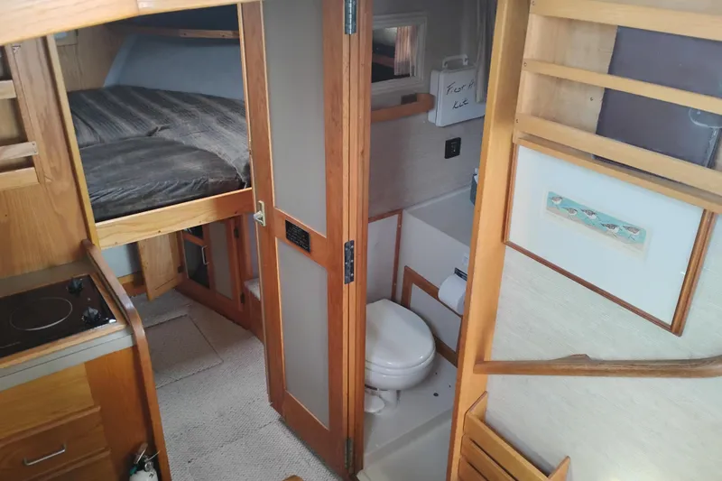 Slide: The Image of Interior of 1985 Mainship 34 Mk III, featuring cozy cabin and compact bathroom. - 24