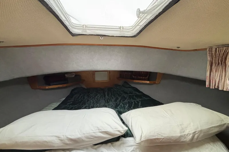 Slide: The Image of Cozy cabin interior of 1985 Mainship 34 III with bedding and skylight. - 25