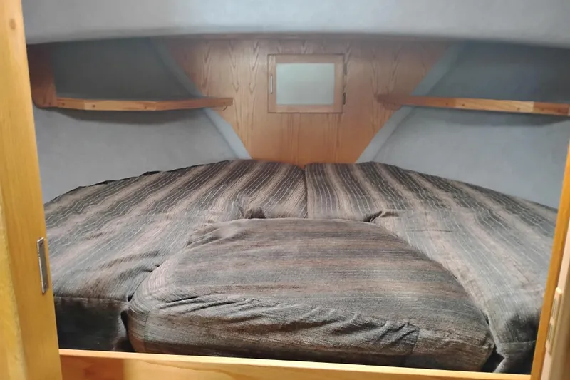 Slide: The Image of Cozy cabin interior of 1985 Mainship 34 Mk III with striped bedding. - 26