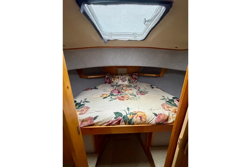Slide: The Image of Interior of 1985 Mainship 34 Mk III with floral bedding. - 27