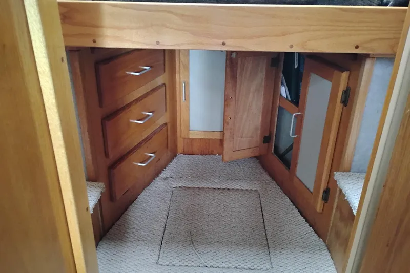 Slide: The Image of Interior of 1985 Mainship 34 Mk III with wooden cabinets and carpeted floor. - 29