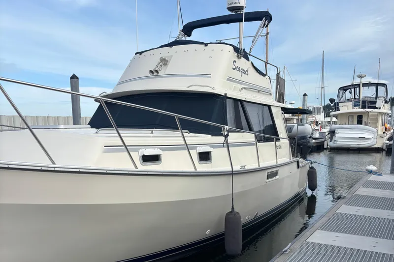 Slide: The Image of 1985 Mainship 34 III docked at marina, featuring classic design and sleek lines. - 4