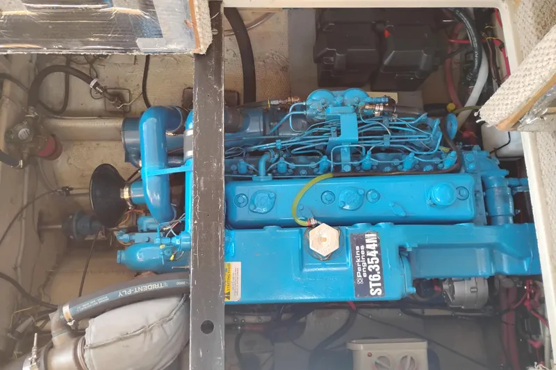 Slide: The Image of Engine compartment of a 1985 Mainship 34 Mk III with a blue Perkins engine. - 40