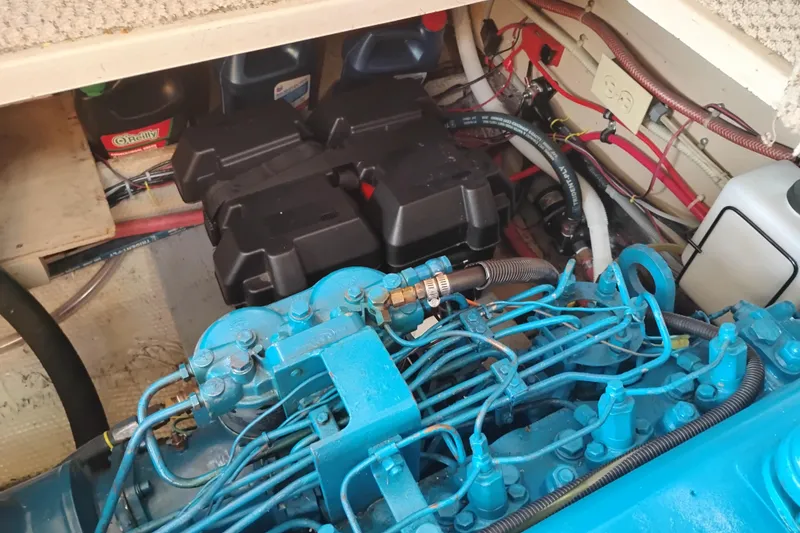 Slide: The Image of Engine compartment of a 1985 Mainship 34 Mk III with visible wiring and components. - 41