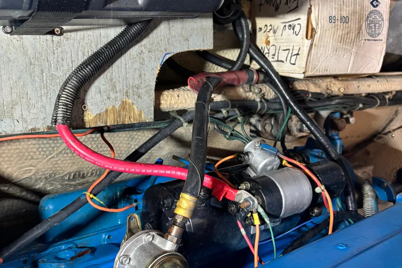 Slide: The Image of Engine compartment of a 1985 Mainship 34 III with visible wiring and components. - 43