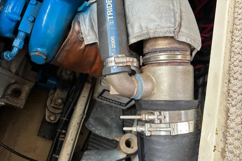 Slide: The Image of Engine compartment of 1985 Mainship 34 III with hoses and clamps. - 46