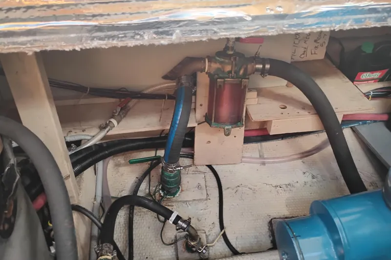 Slide: The Image of Engine compartment of 1985 Mainship 34 Mk III with hoses and filter system. - 47