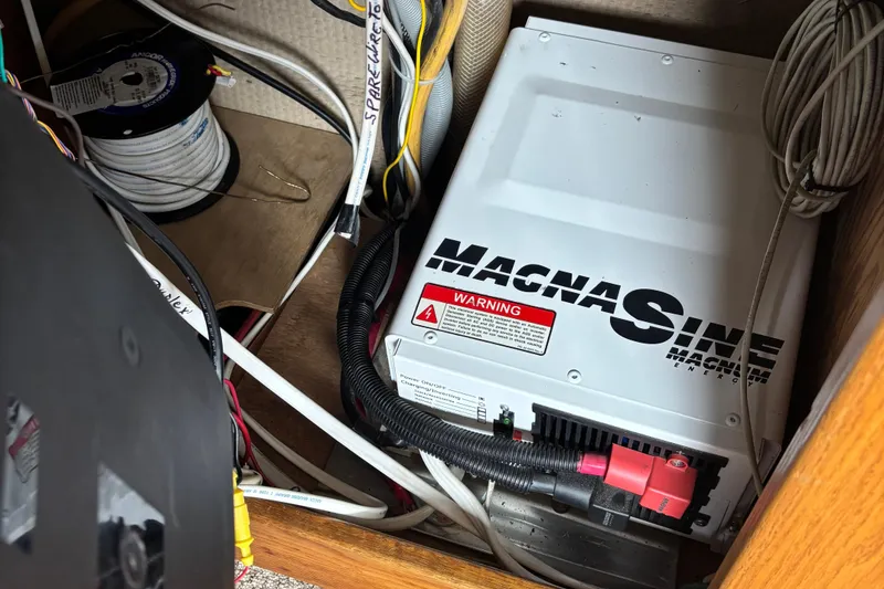 Slide: The Image of Electrical setup in a 1985 Mainship 34 III boat featuring a Magnum Energy inverter. - 51