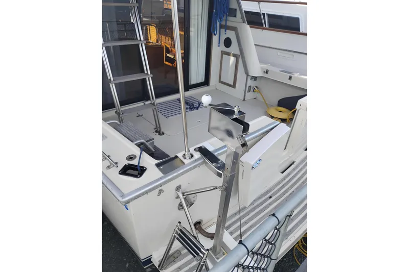 Slide: The Image of 1985 Mainship 34 Mk III boat deck with ladder and seating area. - 52