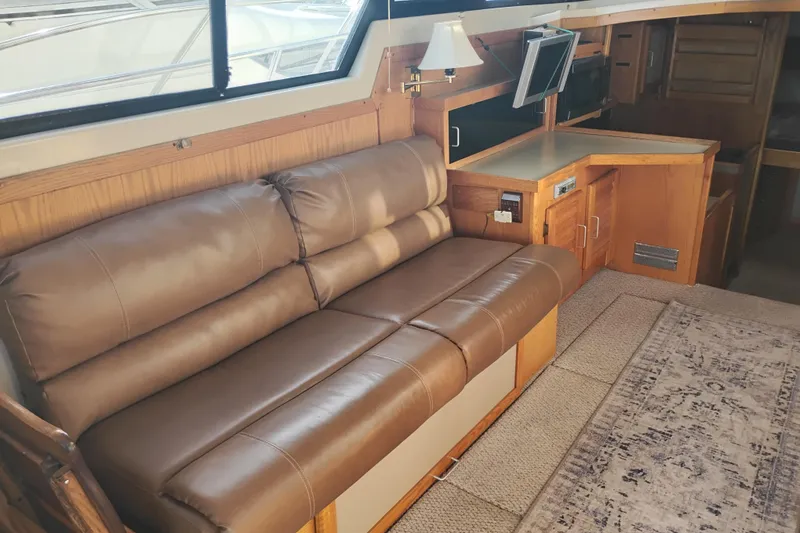 Slide: The Image of Interior of 1985 Mainship 34 Mk III with leather sofa and wooden cabinetry. - 8