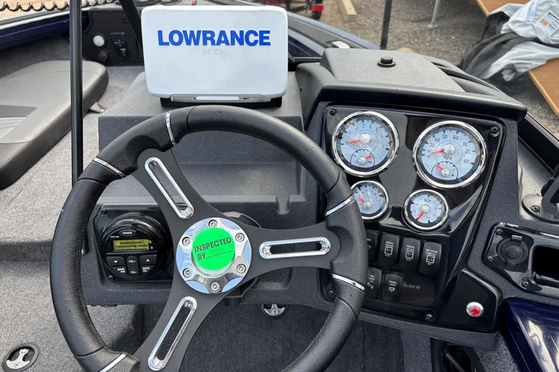 Slide: The Image of 2025 Tracker Targa V-18 Combo dashboard with Lowrance display and gauges. - 5