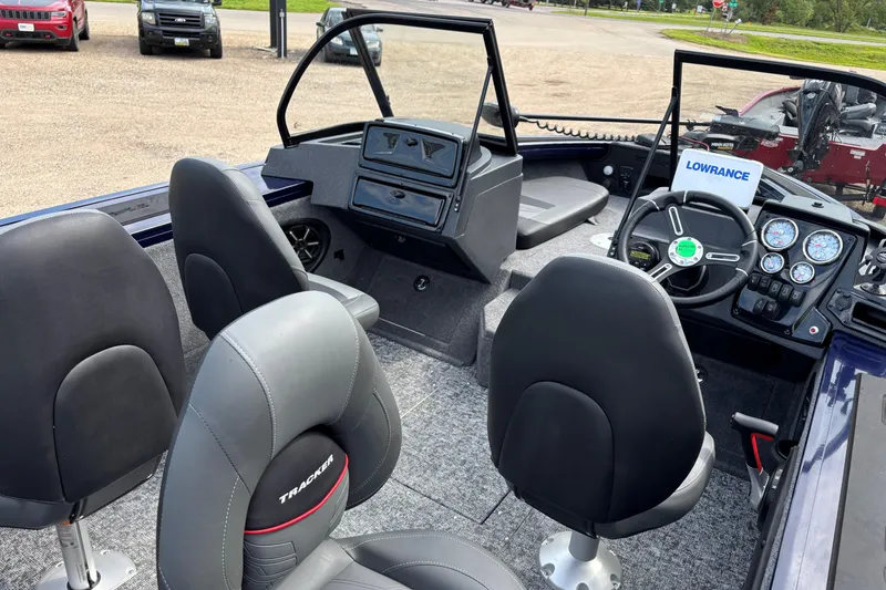 Slide: The Image of 2025 Tracker Targa V-18 Combo boat interior with steering wheel and seating. - 6