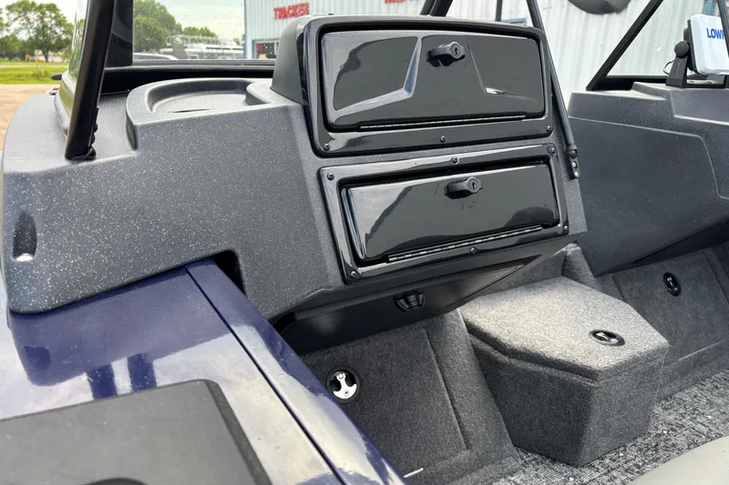 Slide: The Image of 2025 Tracker Targa V-18 Combo boat interior with storage compartments and carpeted flooring. - 8