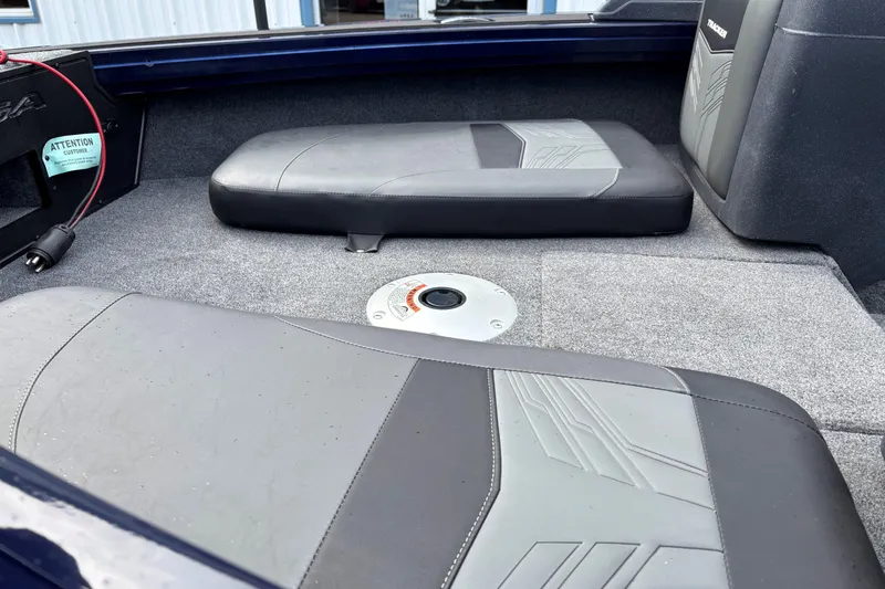 Slide: The Image of 2025 Tracker Targa V-18 Combo boat interior with cushioned seating and carpeted flooring. - 9