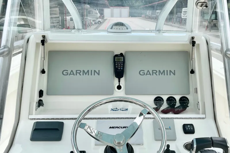 Slide: The Image of 2021 SeaVee 340Z boat dashboard with Garmin displays and Mercury steering wheel. - 12