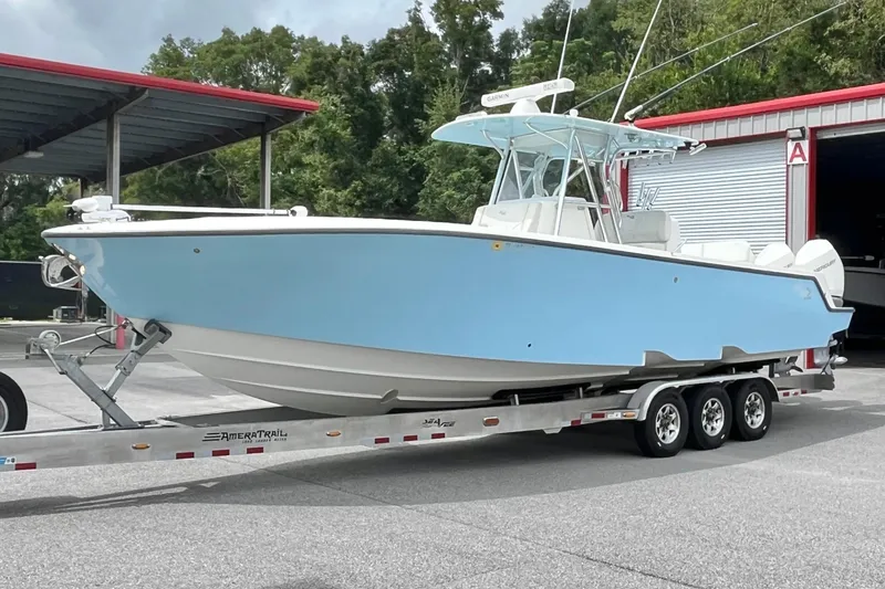 Slide: The Image of 2021 SeaVee 340Z boat on trailer, light blue hull, parked outdoors. - 3