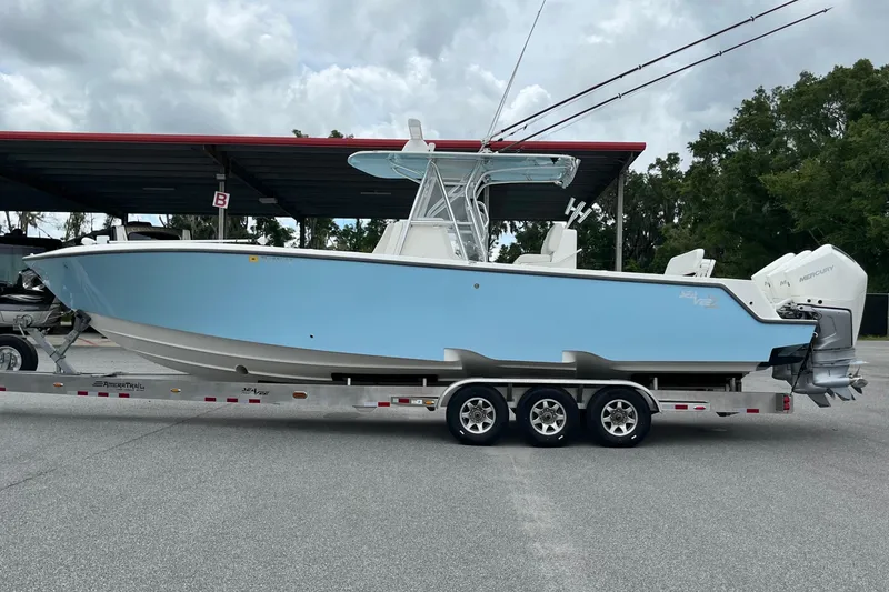 Slide: The Image of 2021 SeaVee 340Z boat on trailer, light blue hull, parked outdoors. - 4