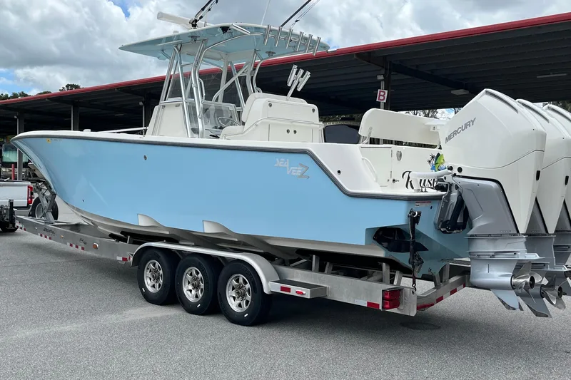 Slide: The Image of 2021 SeaVee 340Z boat on trailer with triple Mercury outboard engines. - 7