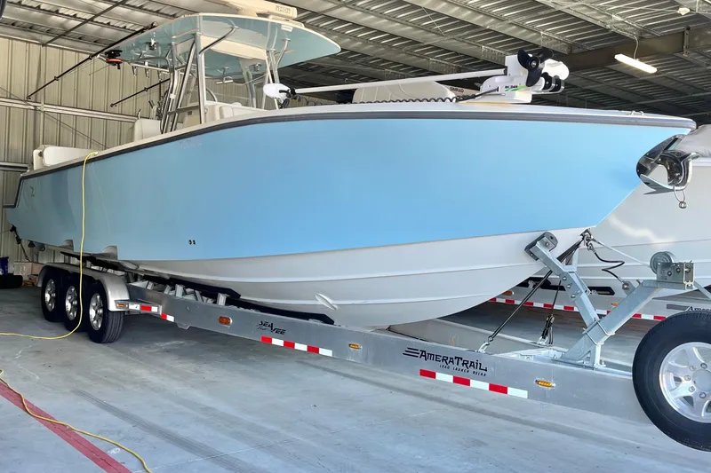 Slide: The Image of 2021 SeaVee 340Z boat on trailer in a garage, light blue hull. - 9