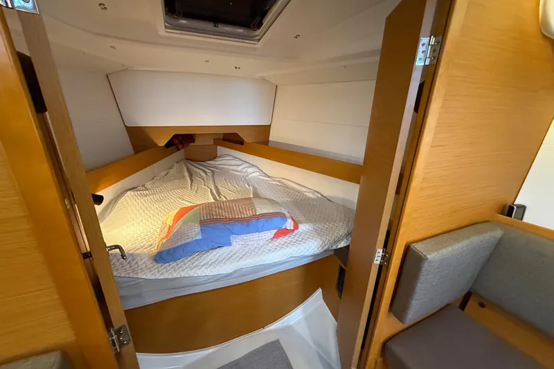 Slide: The Image of Cozy cabin interior of 2016 Jeanneau Sun Odyssey 349 sailboat with comfortable bedding. - 11