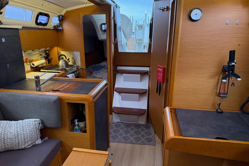 Slide: The Image of Interior of 2016 Jeanneau Sun Odyssey 349 sailboat, featuring cozy kitchen and seating area. - 13
