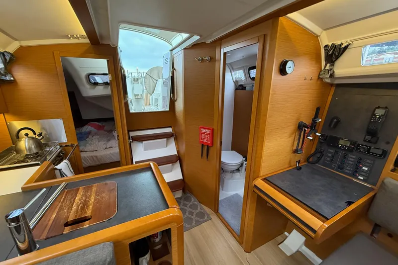 Slide: The Image of Interior of 2016 Jeanneau Sun Odyssey 349 sailboat, featuring kitchen, navigation station, and cozy cabin. - 15