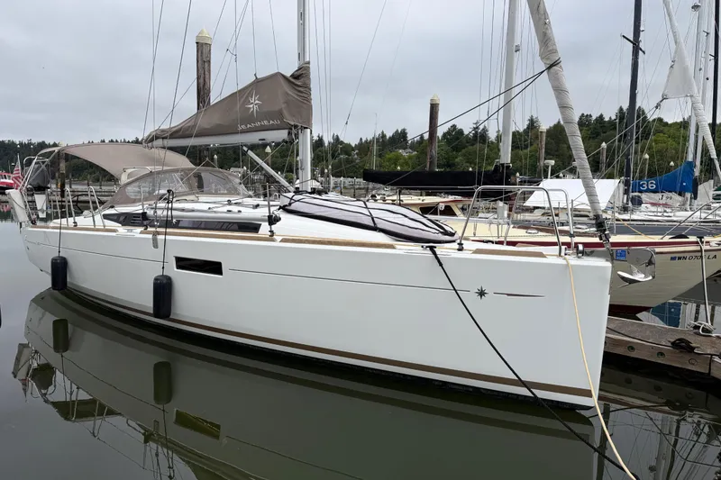 Slide: The Image of 2016 Jeanneau Sun Odyssey 349 sailboat docked in a marina, overcast sky. - 34
