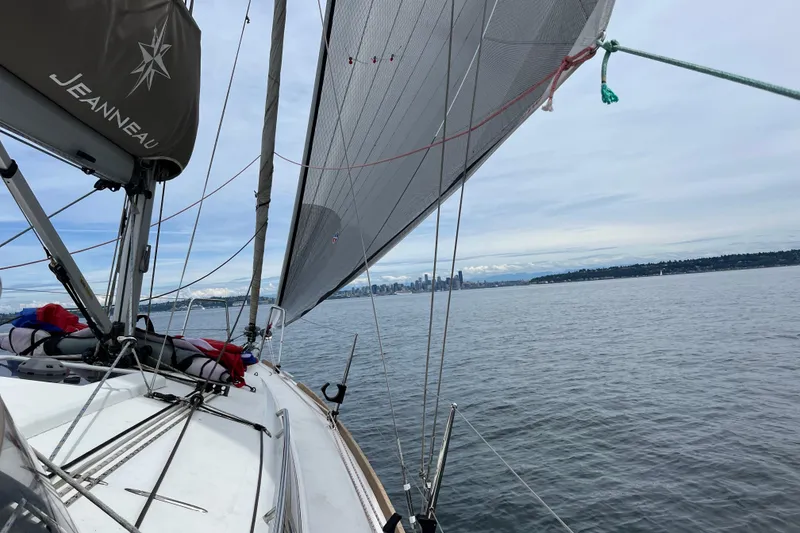 Slide: The Image of 2016 Jeanneau Sun Odyssey 349 sailing with city skyline in the background. - 37