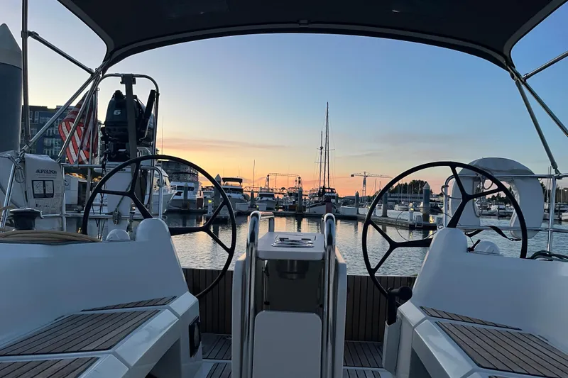 Slide: The Image of Cockpit view of 2016 Jeanneau Sun Odyssey 349 sailboat at sunset in marina. - 40