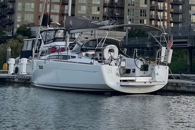 Slide: The Image of 2016 Jeanneau Sun Odyssey 349 sailboat docked in marina, urban backdrop. - 41