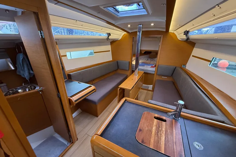 Slide: The Image of Interior of 2016 Jeanneau Sun Odyssey 349 sailboat, featuring cozy seating and modern amenities. - 6