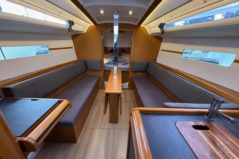 Slide: The Image of Interior of 2016 Jeanneau Sun Odyssey 349 sailboat, featuring cozy seating and modern design. - 7