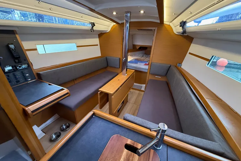Slide: The Image of Interior of 2016 Jeanneau Sun Odyssey 349 sailboat with modern seating and wood finish. - 8