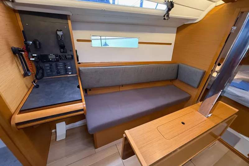 Slide: The Image of Interior of 2016 Jeanneau Sun Odyssey 349 sailboat with navigation station and seating area. - 9