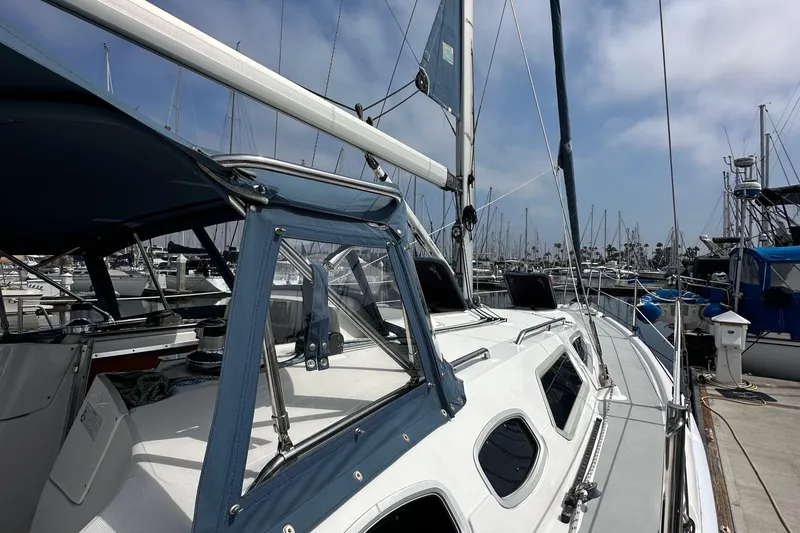 Slide: The Image of 2008 Hunter 36 sailboat docked at marina under clear sky. - 11