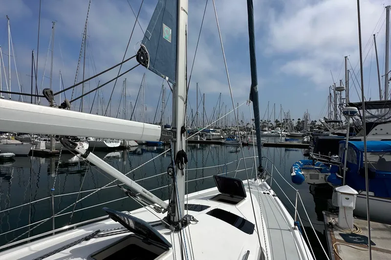 Slide: The Image of Sailboat Hunter 36, 2008 model, docked in a marina with numerous masts in the background. - 12