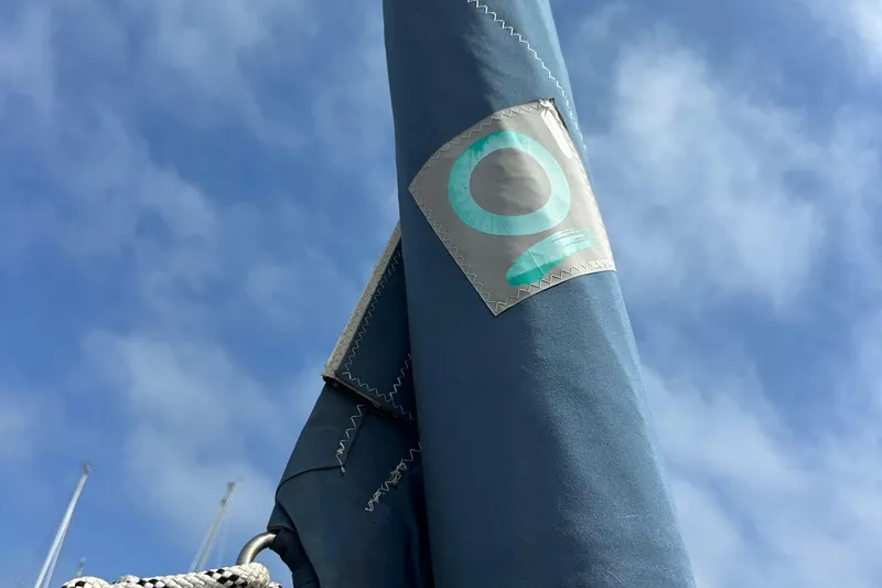 Slide: The Image of Blue sail cover on a 2008 Hunter 36 sailboat against a clear sky. - 17